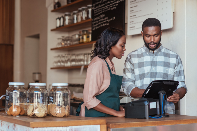 A man and a woman on the counter looking at the screen